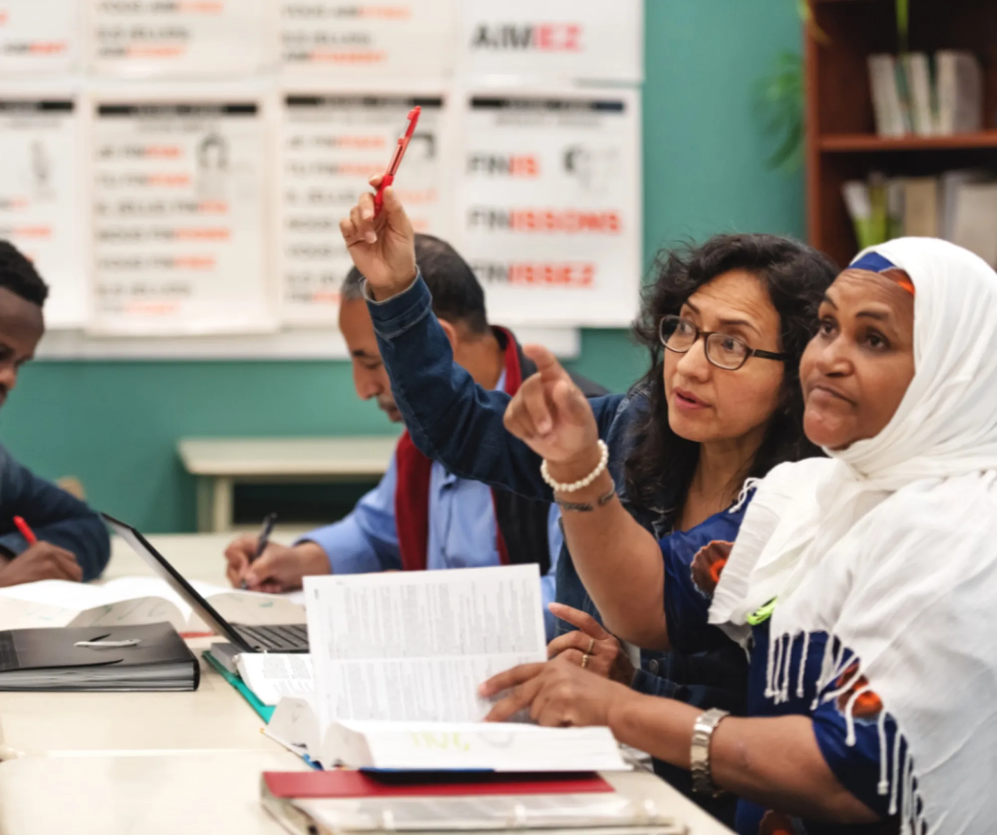 A teacher leading an engaged group of adult learners