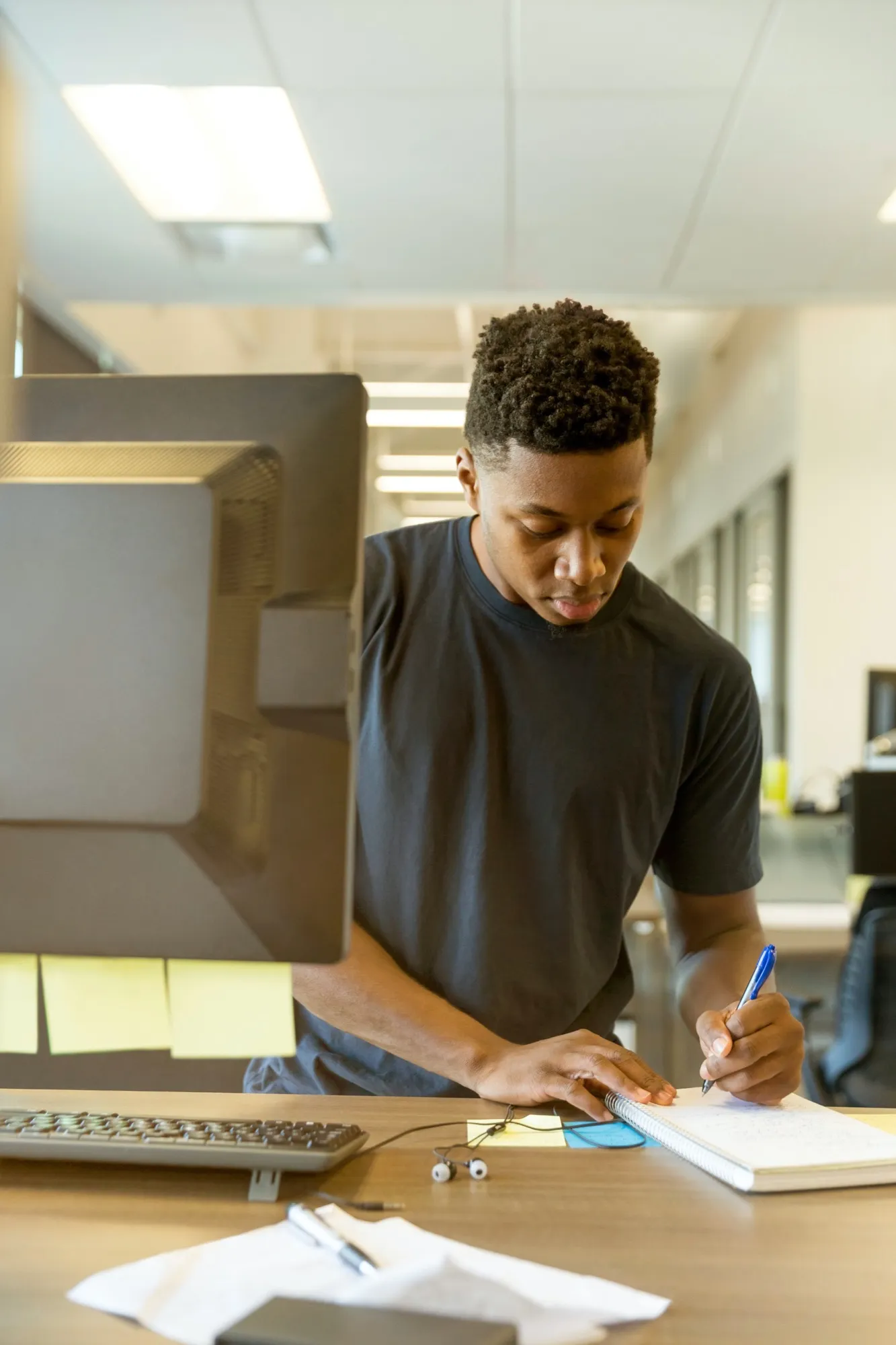 A young man reviewing paperwork at a desk