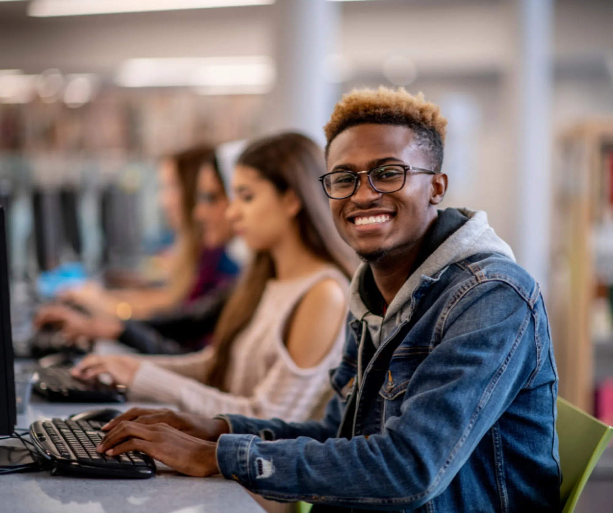 Students working together at computers in a classroom