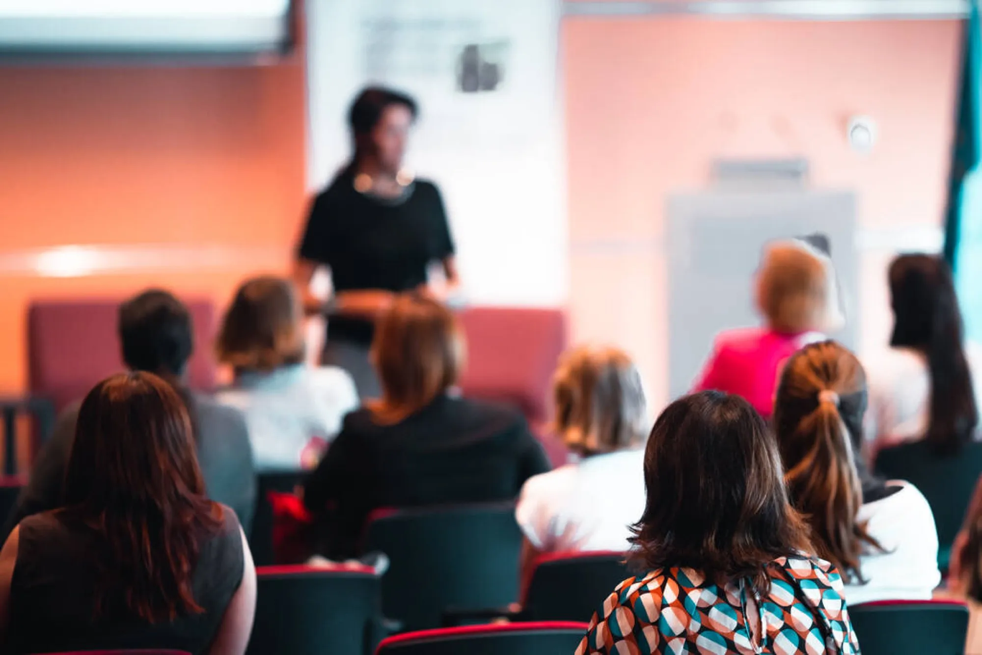 An audience listening to a presenter at a workshop